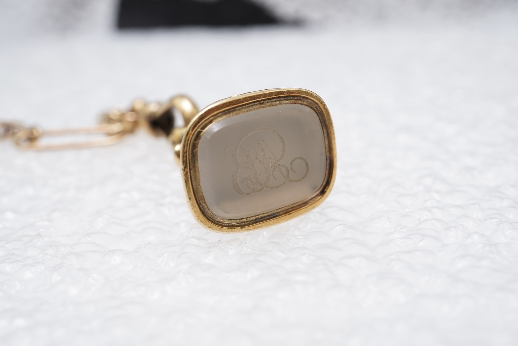 A gold watch chain, toothpick and fob seal